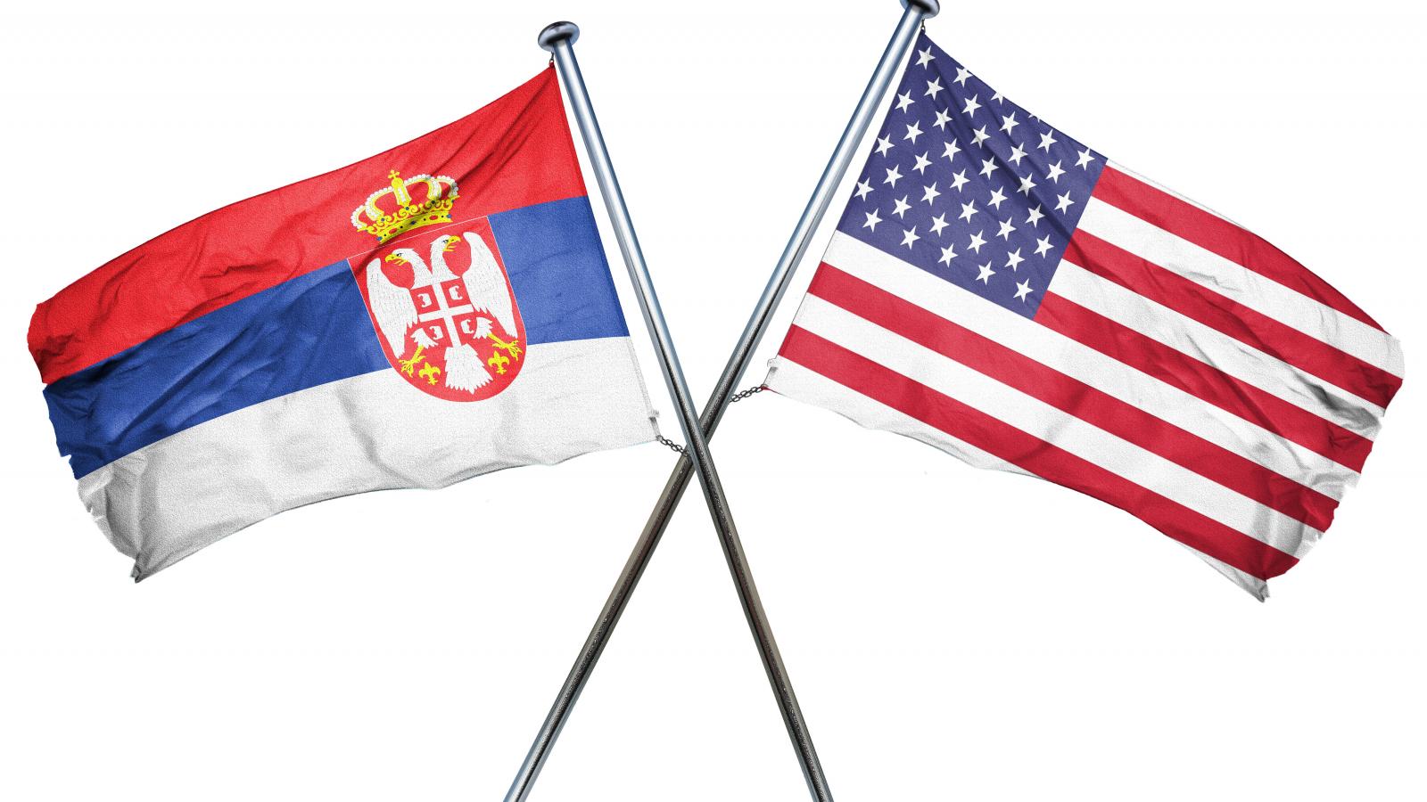 Serbian and U.S. flag crossed over each other