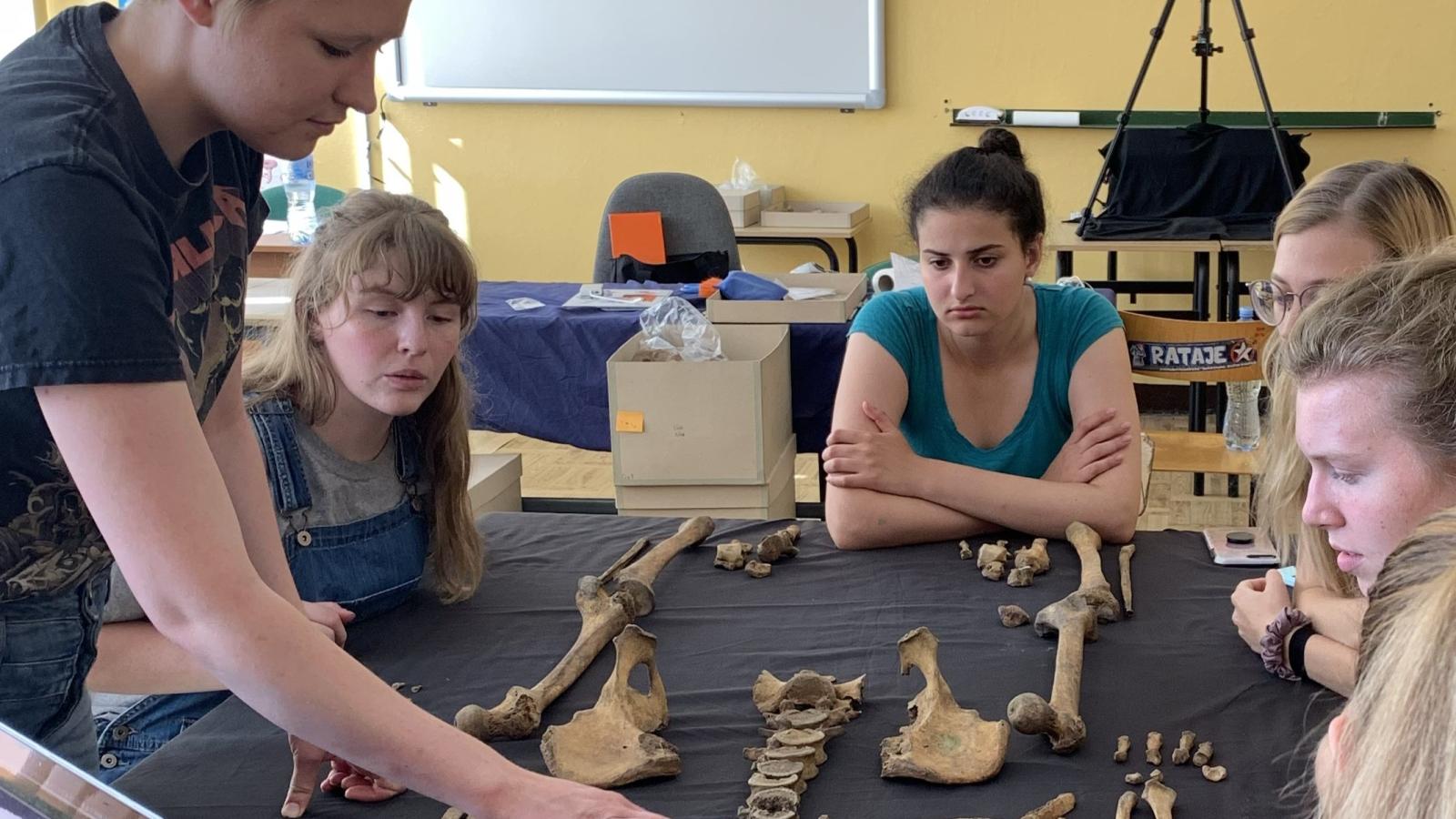 Students studying at the mortuary field school in Giecz, Poland