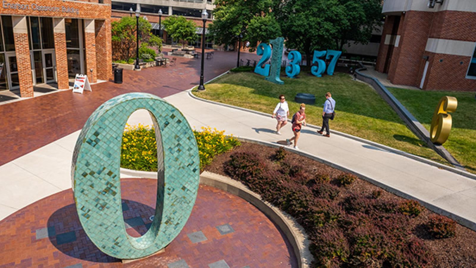 Photograph of The Garden of Constants Public Art with Enarson Classroom Building and parking garage in background.. Artist Barbara Grygutis