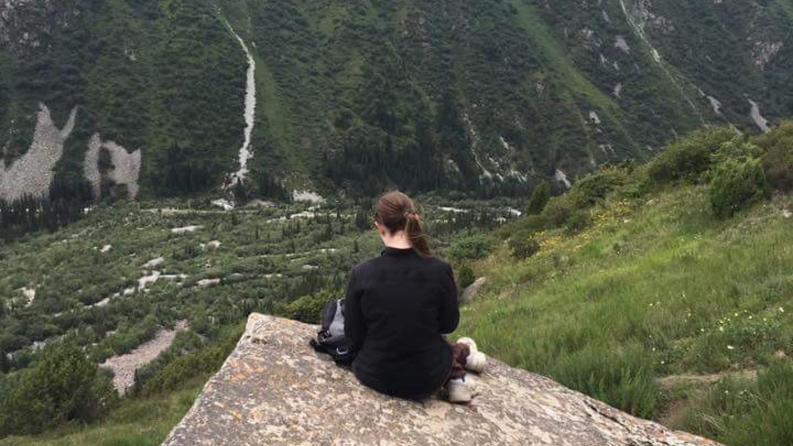 Amelia Smith enjoying the view off a mountain in Kyrgyzstan