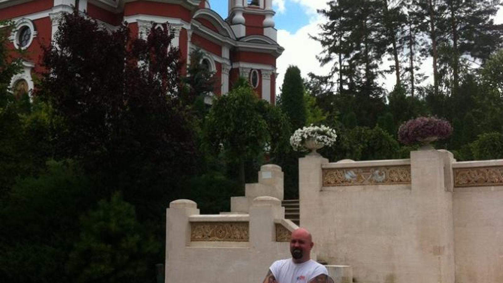 Justin standing by a Moldovan church