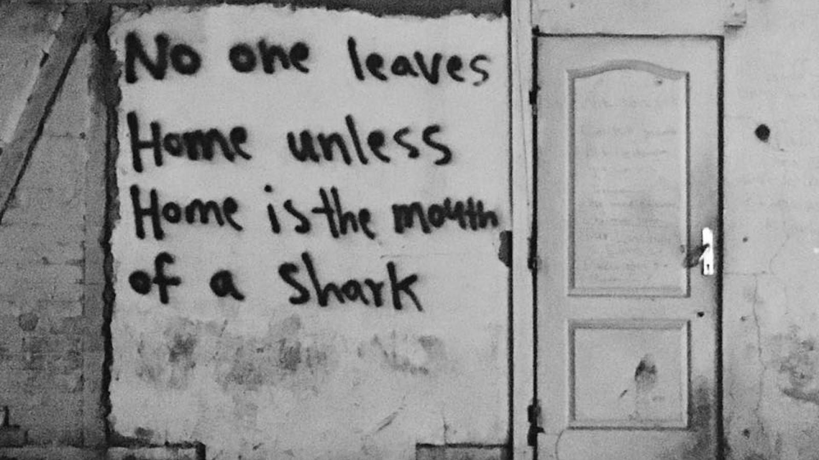 No One Leaves Home Unless Home is the Mouth of a Shark graffiti on a building 