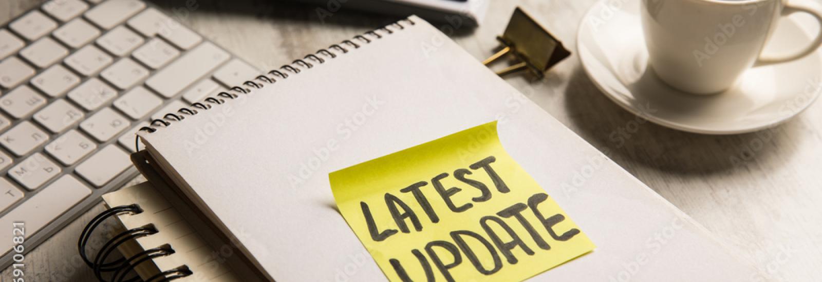 sticky note on a note book that reads "latest update"